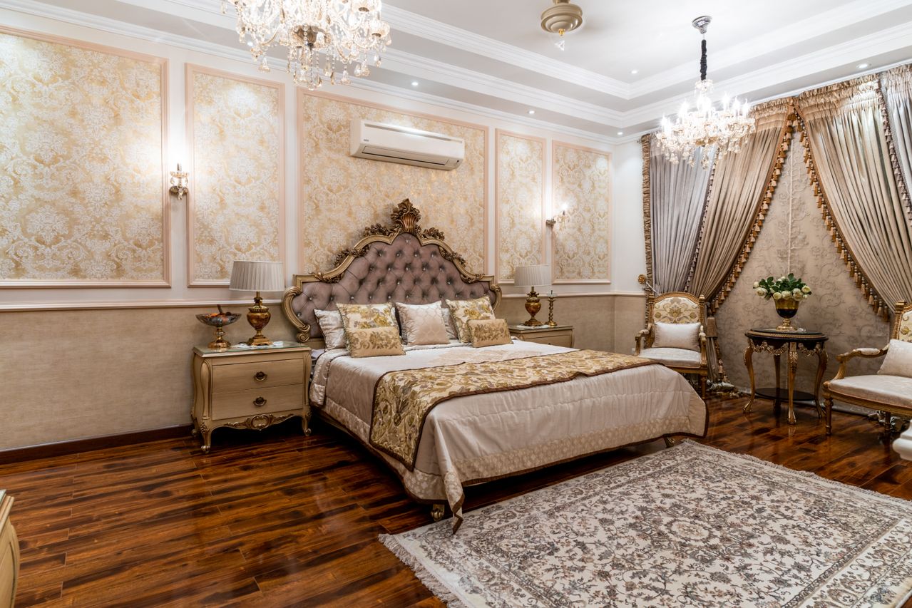 Ornate gold suite with crystal chandeliers and cream seating