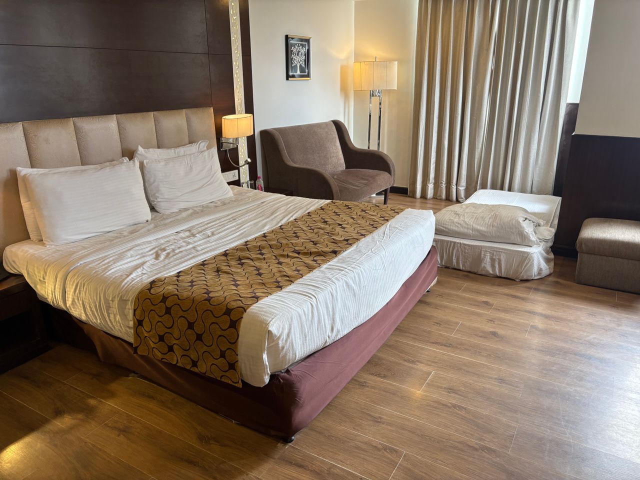 Warm guest room with wood panelling and sitting area